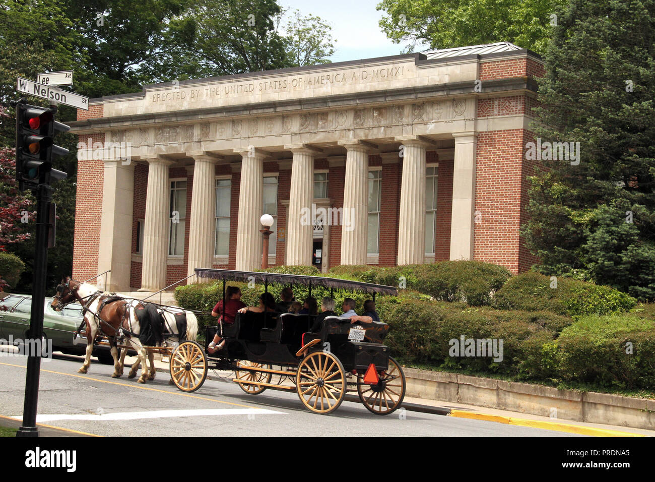 Carriage ride in downtown Lexington, VA, USA. The Post Office building