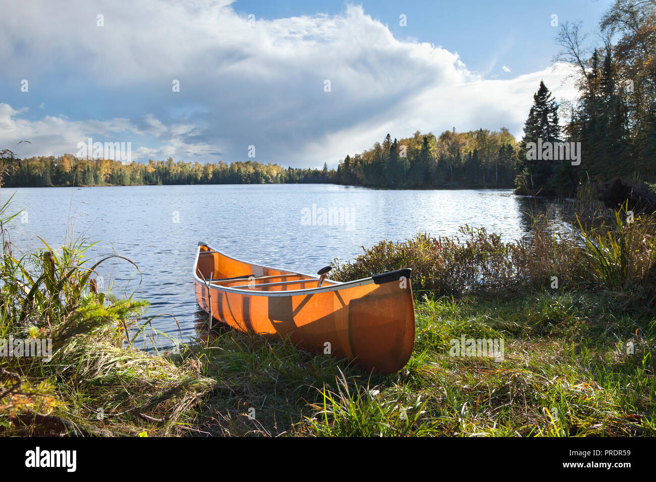 Canoe on the shore of a beautiful northern Minnesota lake during autumn Stock Photo