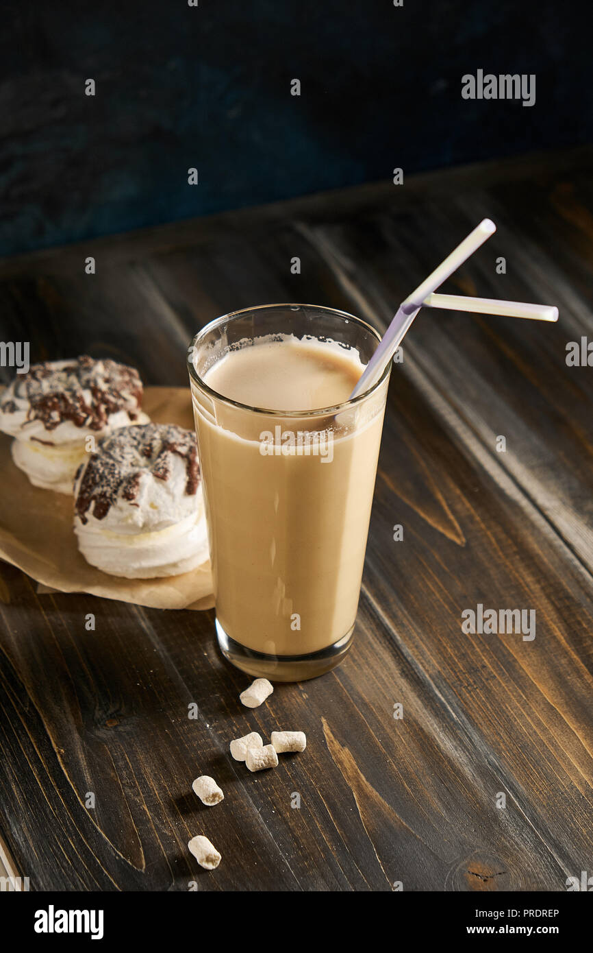 https://c8.alamy.com/comp/PRDREP/iced-coffee-in-tall-glasses-with-milk-and-straws-on-board-over-rustic-wooden-table-white-wall-and-jug-at-background-copy-space-summer-refreshing-beverage-ice-coffee-drink-concept-PRDREP.jpg