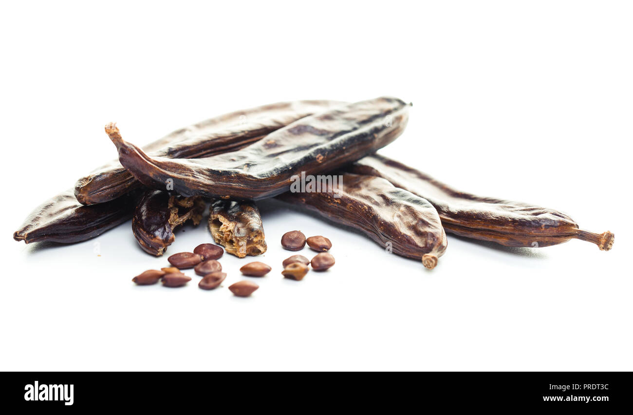 Carob pods and seeds on white background Stock Photo Alamy
