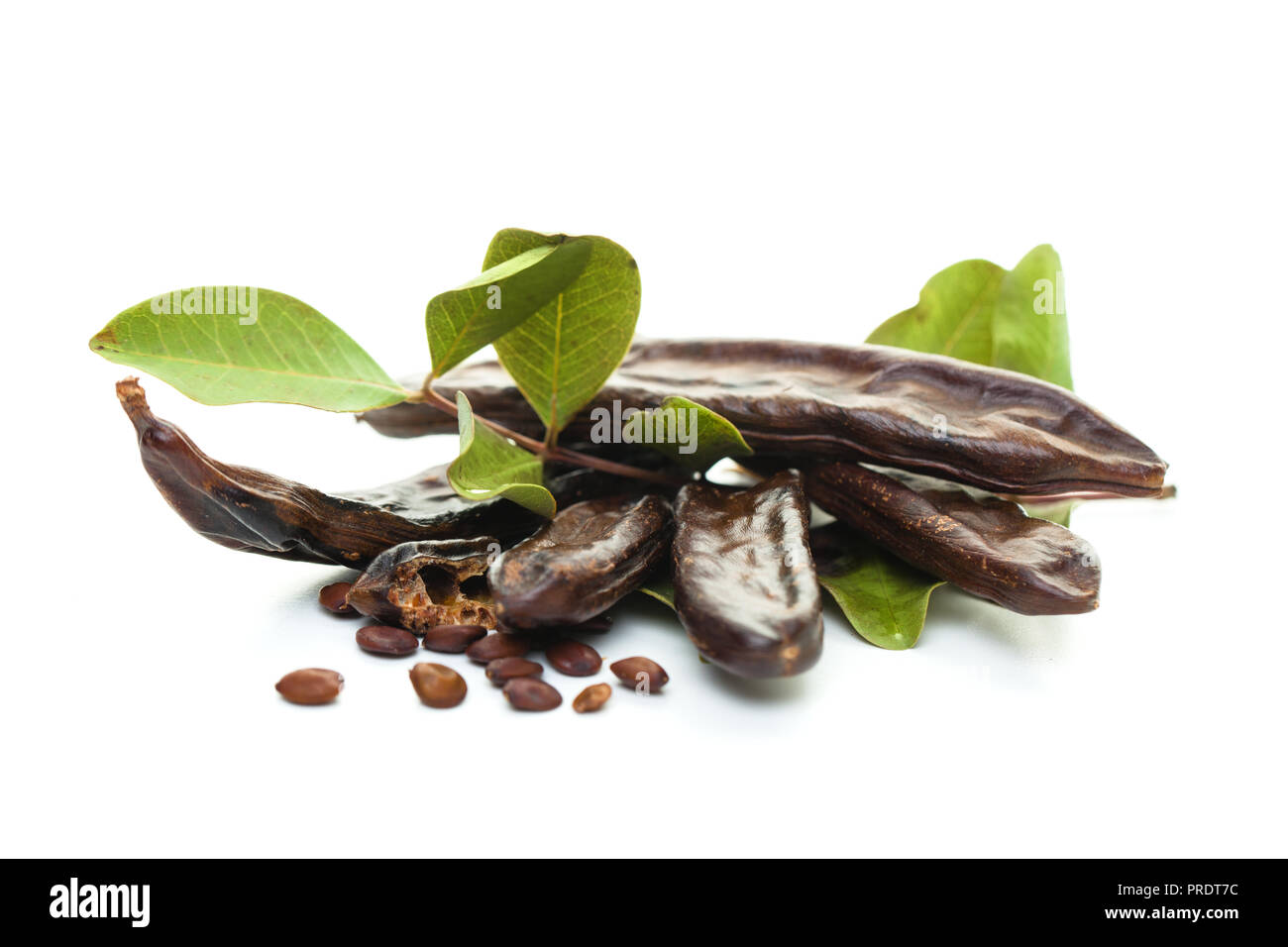 Carob on white background. Healthy organic sweet carob pods with seeds