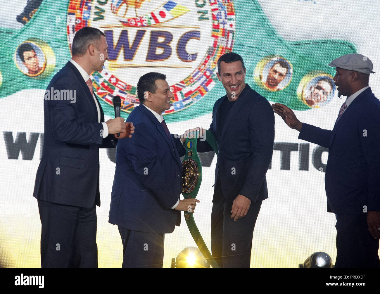 Kiev, Ukraine. 1st Oct, 2018. Mauricio Sulaiman, President of the World Boxing Council (WBC) (2-L) is seen giving the WBC honorary champion belt to Vladimir Klitschko, Ukrainian boxing Champion (2-R), while Vitali Klitschko, former heavyweight boxing champion and current Mayor of Kiev (L) and Lennox Lewis, former Boxing Champion (R) look on, during ceremony of opening of the 56th WBC Convention in Kiev, Ukraine. The 56th WBC Convention in which take part boxing legends Evander Holyfield, Lennox Lewis, Eric Morales and about 700 participants from 160 countries runs in Kiev from September 30 Stock Photo