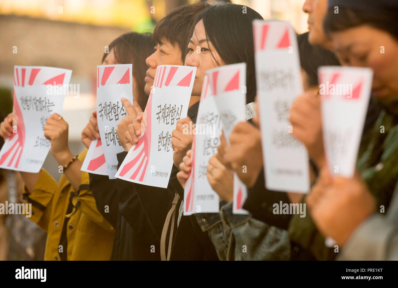 Protest against Japanese rising sun flag in South Korea, Oct 1, 2018 : South Korean activists from civic groups attend a press conference in front of the Japanese embassy in Seoul, South Korea. The protesters criticized Japan and its navy planning to display Japanese Rising Sun Flag, which protesters think as a symbol of wartime aggression, during the International Fleet Review to be held off the island of Jeju, South Korea from October 10-14. Navy ships from 15 countries including Japan, China and the U.S. will participate in the event. South Korean navy said on Sunday it remains in oppositio Stock Photo