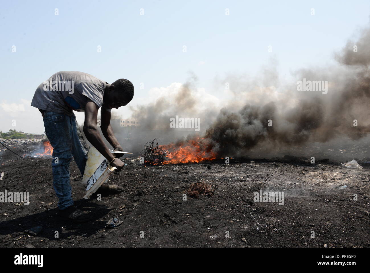 Accra, Ghana. 12th June, 2018. At the Agbogbloshie scrap yard, men burn cables and other parts