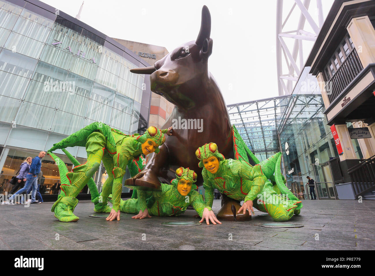 Birmingham, UK. 2nd October, 2018. Three of the cast of crickets in Cirque de Soleil's OVO show arrive in Birmingham Bull Ring ahead of their premiere performance on Wednesday 3rd October in The Arena, Birmingham. The production of one of the world's most creative and skilful circuses runs from 3rd - 7th October 2018. Peter Lopeman/Alamy Live News Stock Photo