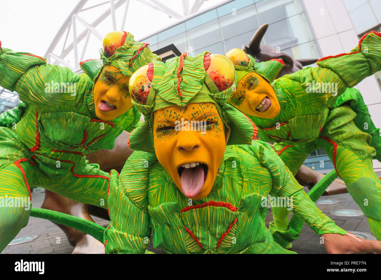 Birmingham, UK. 2nd October, 2018. Three of the cast of crickets in Cirque de Soleil's OVO show arrive in Birmingham Bull Ring ahead of their premiere performance on Wednesday 3rd October in The Arena, Birmingham. The production of one of the world's most creative and skilful circuses runs from 3rd - 7th October 2018. Peter Lopeman/Alamy Live News Stock Photo