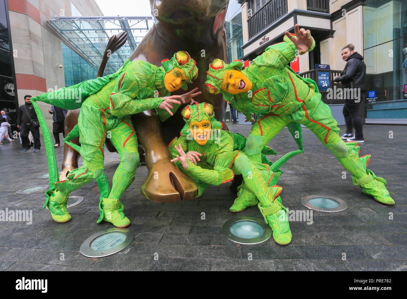 Birmingham, UK. 2nd October, 2018. Three of the cast of crickets in Cirque de Soleil's OVO show arrive in Birmingham Bull Ring ahead of their premiere performance on Wednesday 3rd October in The Arena, Birmingham. The production of one of the world's most creative and skilful circuses runs from 3rd - 7th October 2018. Peter Lopeman/Alamy Live News Stock Photo