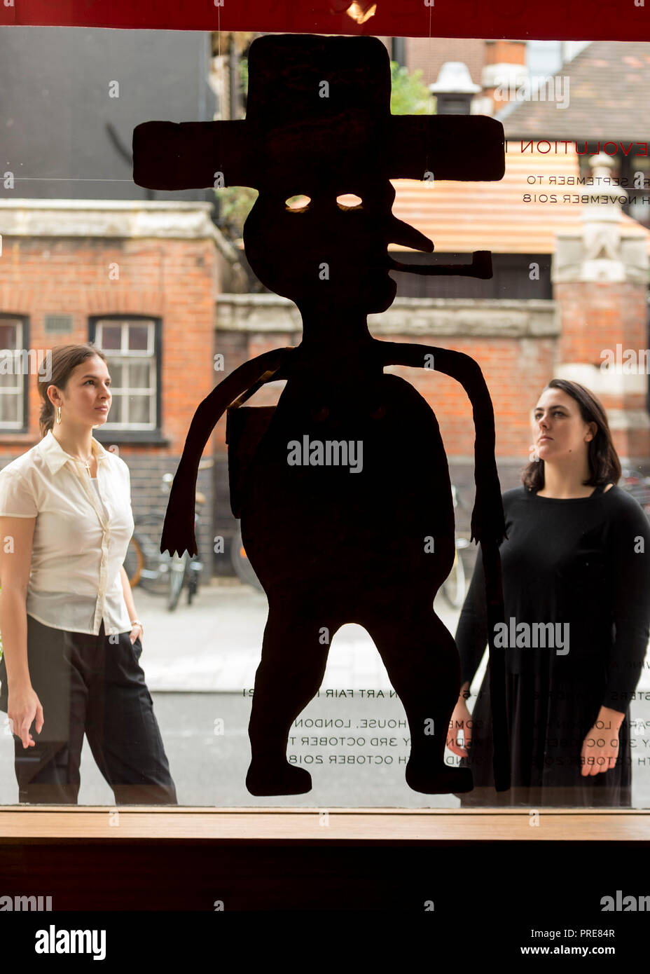 London, UK.  2 October 2018. Staff members view a sculpture by Georges Liautaud. Preview of "Art + Revolution in Haiti", an exhibition at The Gallery of Everything in Chiltern Street.  The exhibition, which coincides with Frieze Week, explores when Surrealism arrived in the former slave colony in 1945.  Works from artists from le Centre d'Art d'Haiti and from the personal collection of Andre Breton, the founder of Surrealism, are on display until 11 November 2018.   Credit: Stephen Chung / Alamy Live News Stock Photo