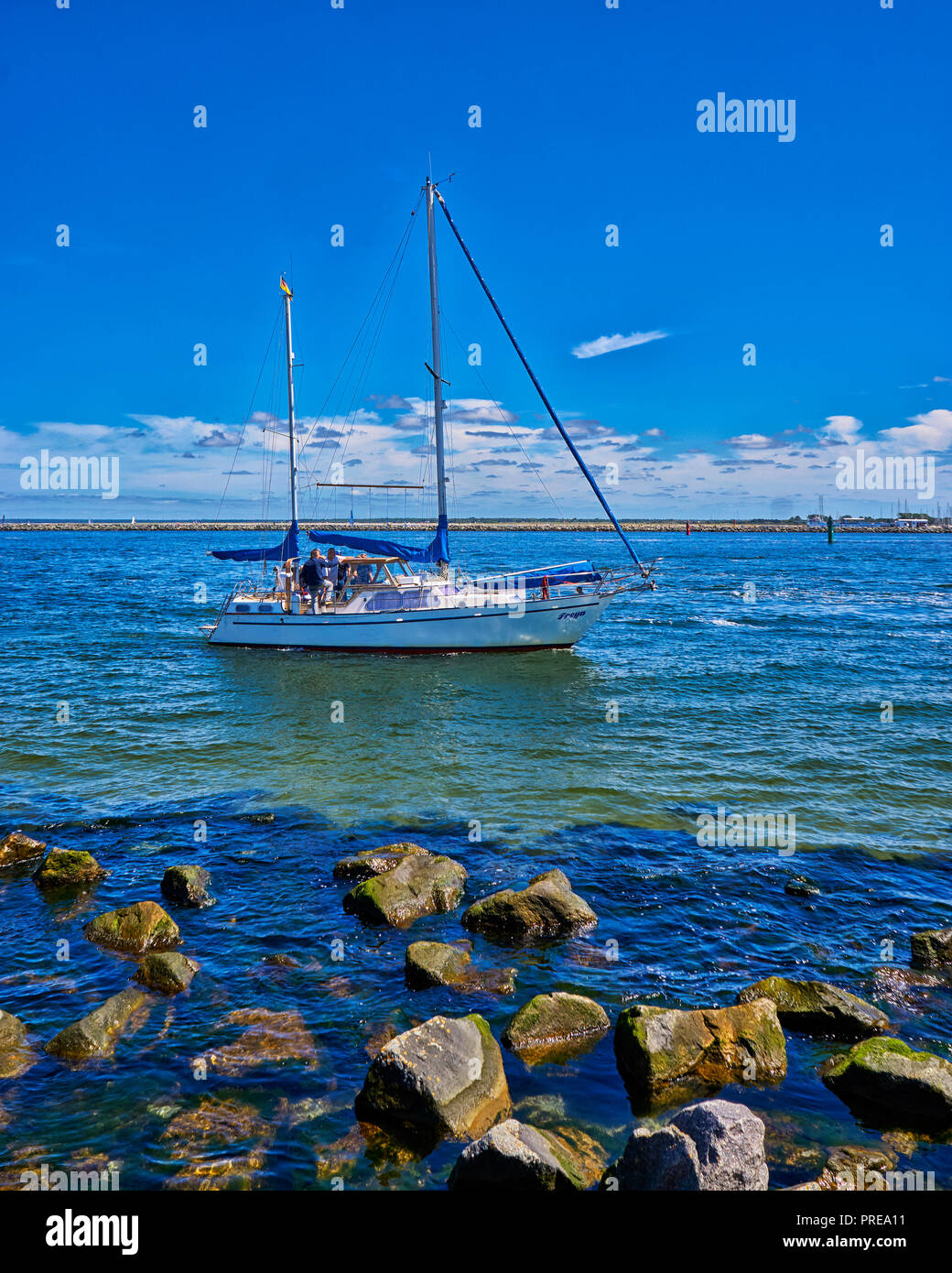 Stones and sailboat at the beach in Mecklenburg-Vorpommern, Germany Stock Photo