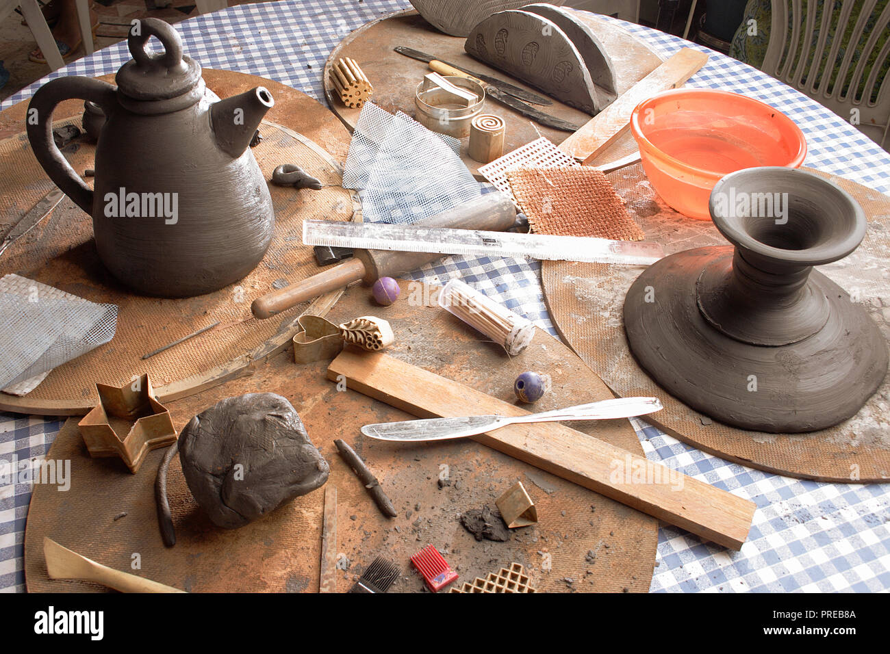 STILL LIFE OF VARIOUS TOOLS AND MATERIALS USED IN POTTERY MAKING 