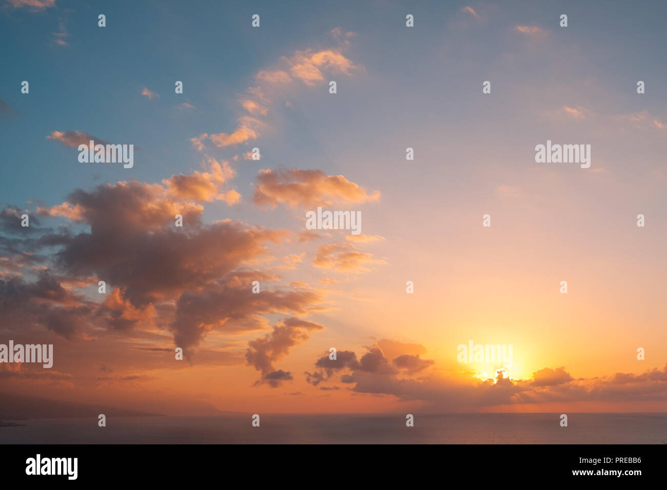 sunset sky above ocean background - scenic sky over water - colorful cloudy sky with evening sun Stock Photo