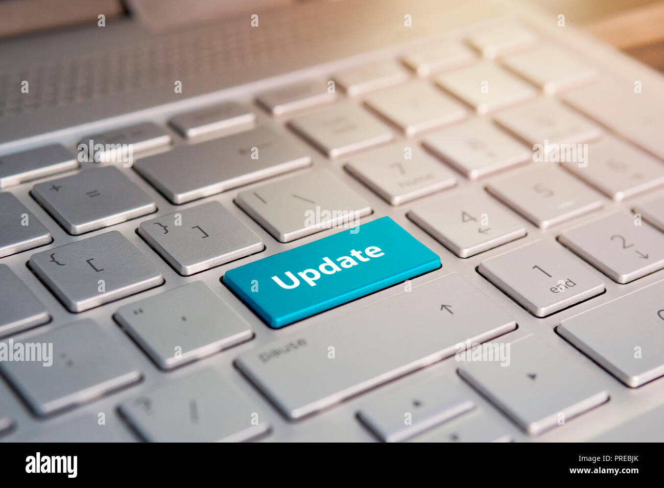 Update Button on Keyboard. Blue Color button on the gray silver keyboard of modern ultrabook. caption on the button Stock Photo