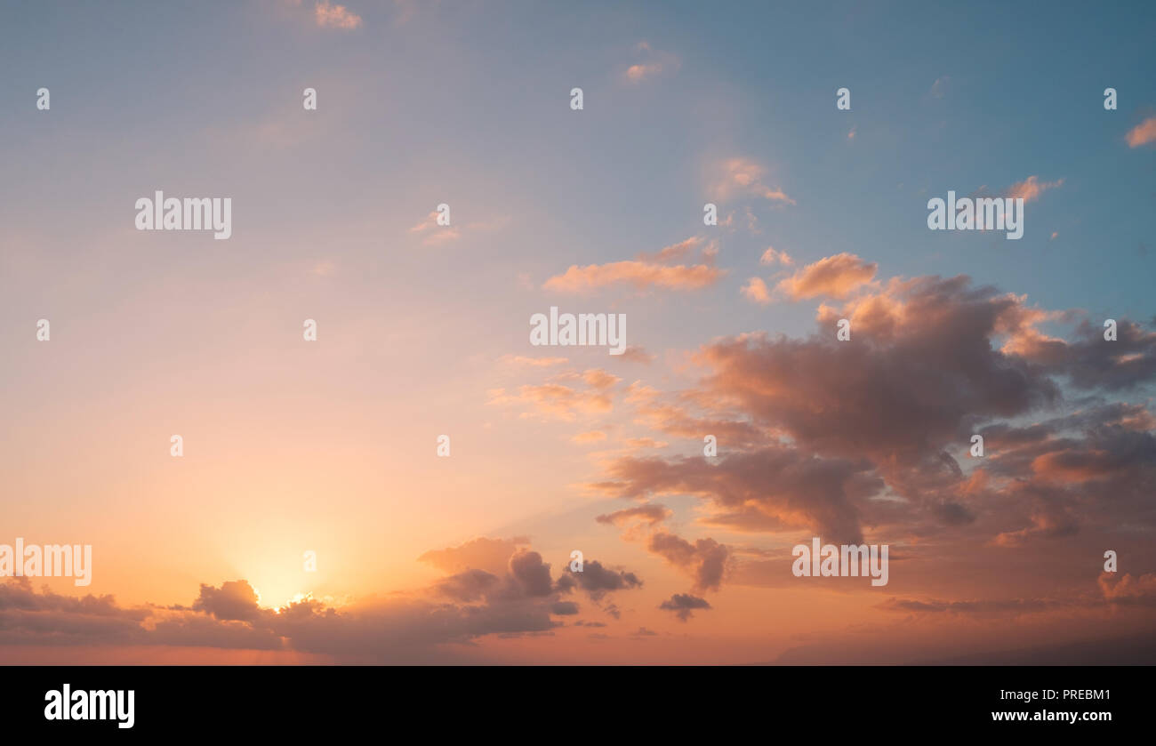 sunset sky  background - sun behind colorful clouds Stock Photo