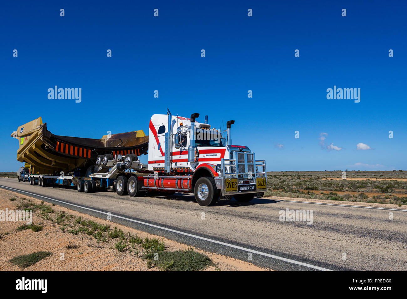 Road trains hauling mining equipment across the Nullabor Plain in South Australia Stock Photo