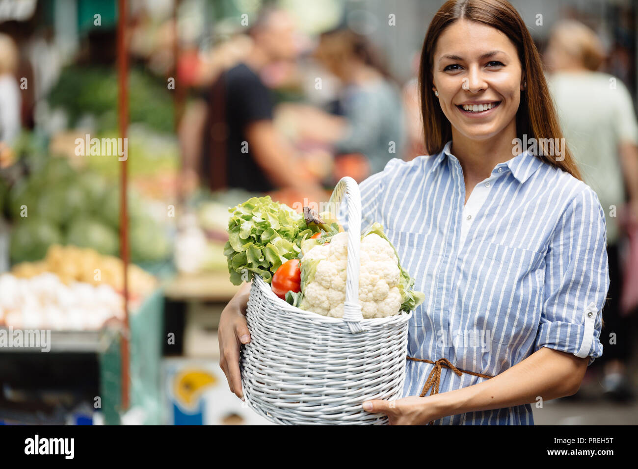 Portrait of beautiful woman holding shopping basket Stock Photo - Alamy