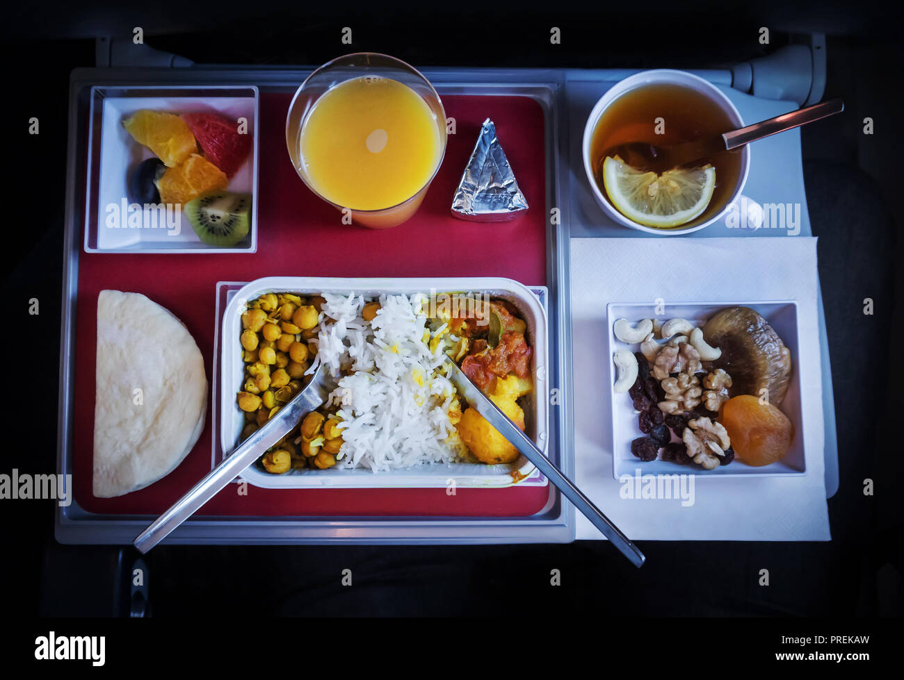 the food on Board the plane. various products on the folding table. Stock Photo