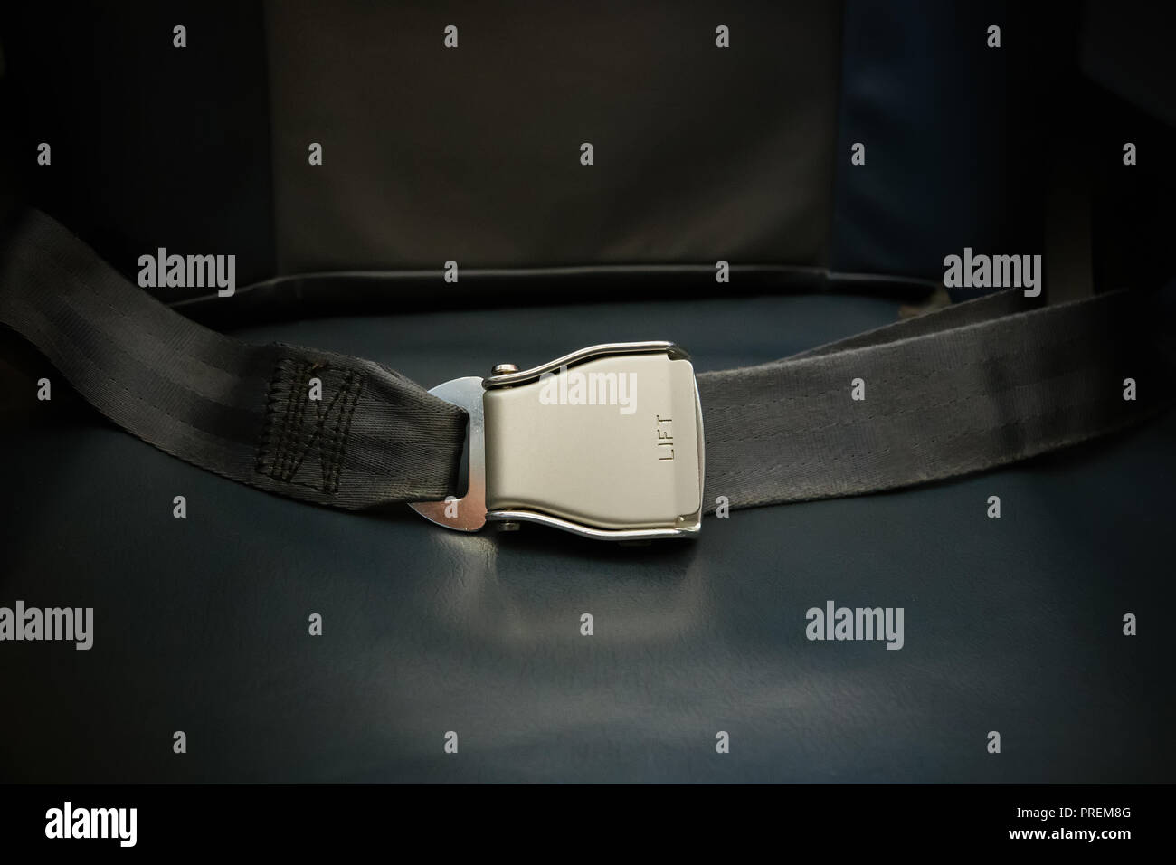 Seat belt on seat shot in airplane. Dark tone and Selective focus