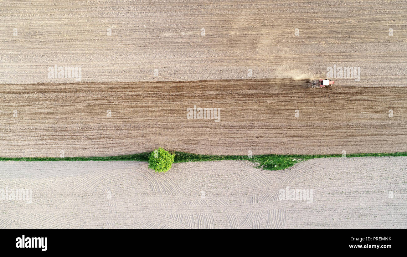 Tractor working on field seen from the drone Stock Photo