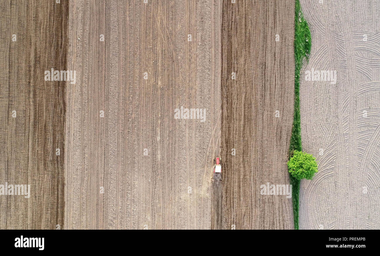 Tractor working on field seen from the drone Stock Photo