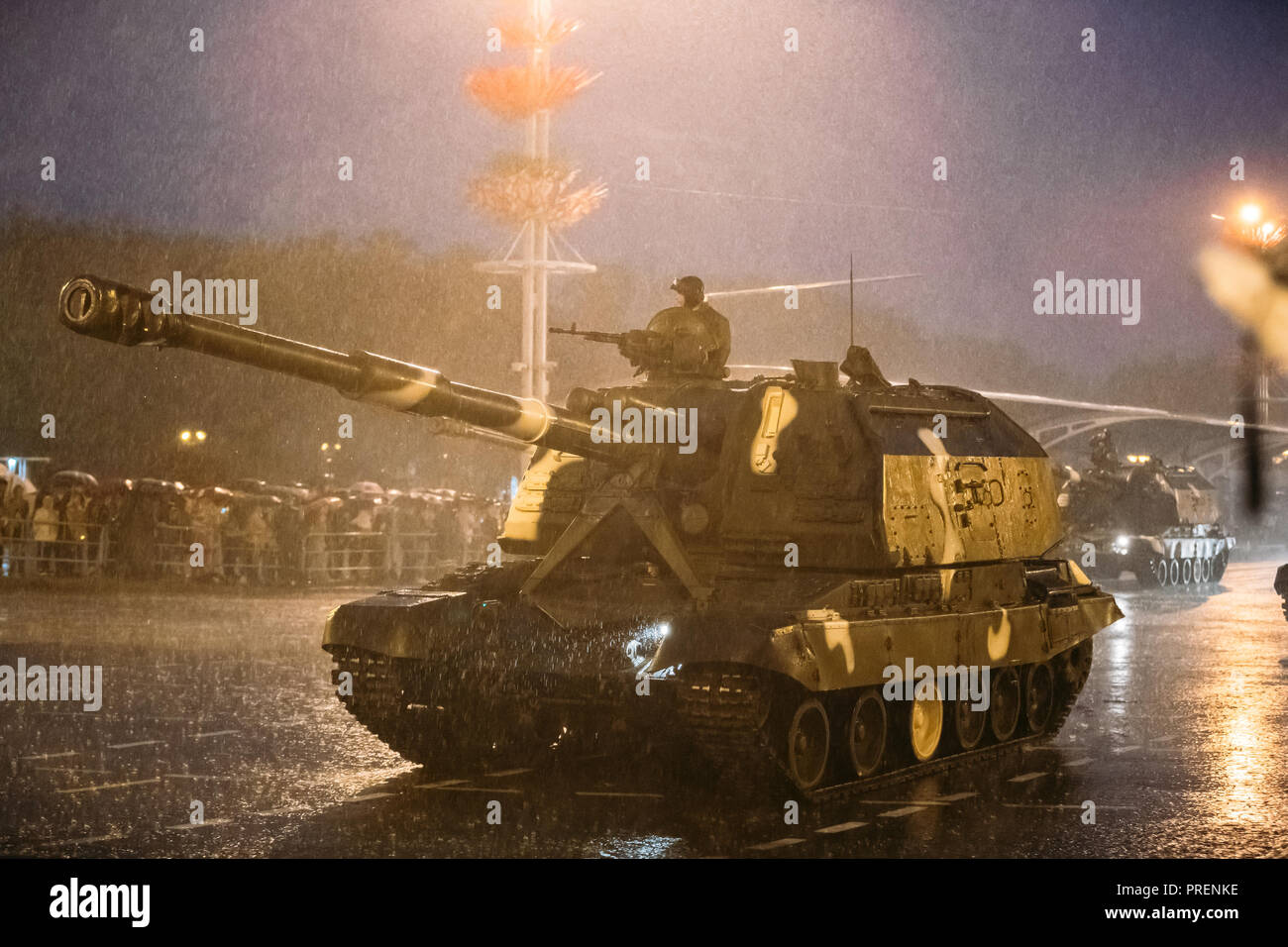 Minsk, Belarus. Military Self-propelled Guns Moving At Street During Rehearsal Before Celebration Of Independence Day Of Belarus. Evening Rainy Time. Stock Photo