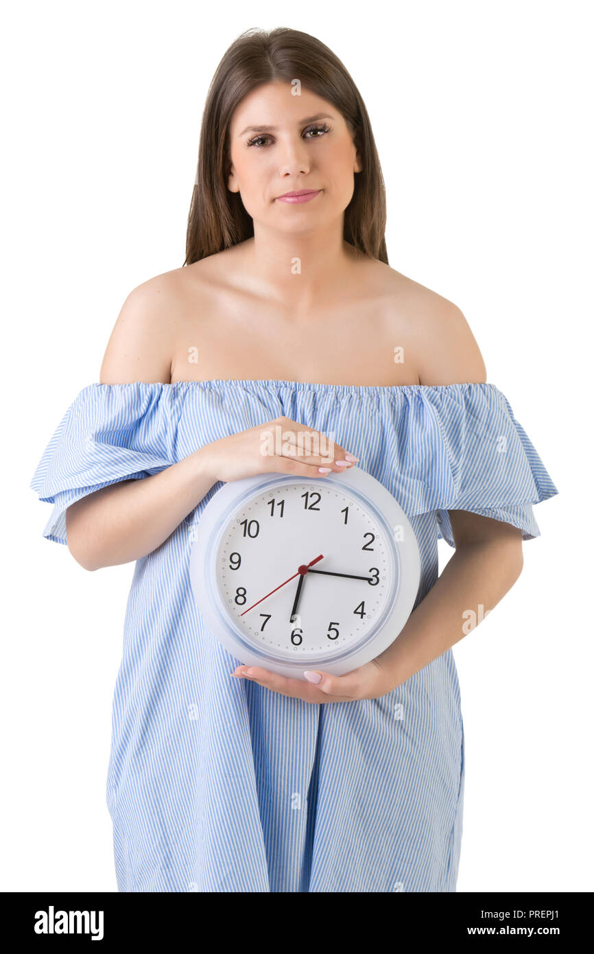 Female holding a clock, isolated in white. Biological clock concept. Stock Photo