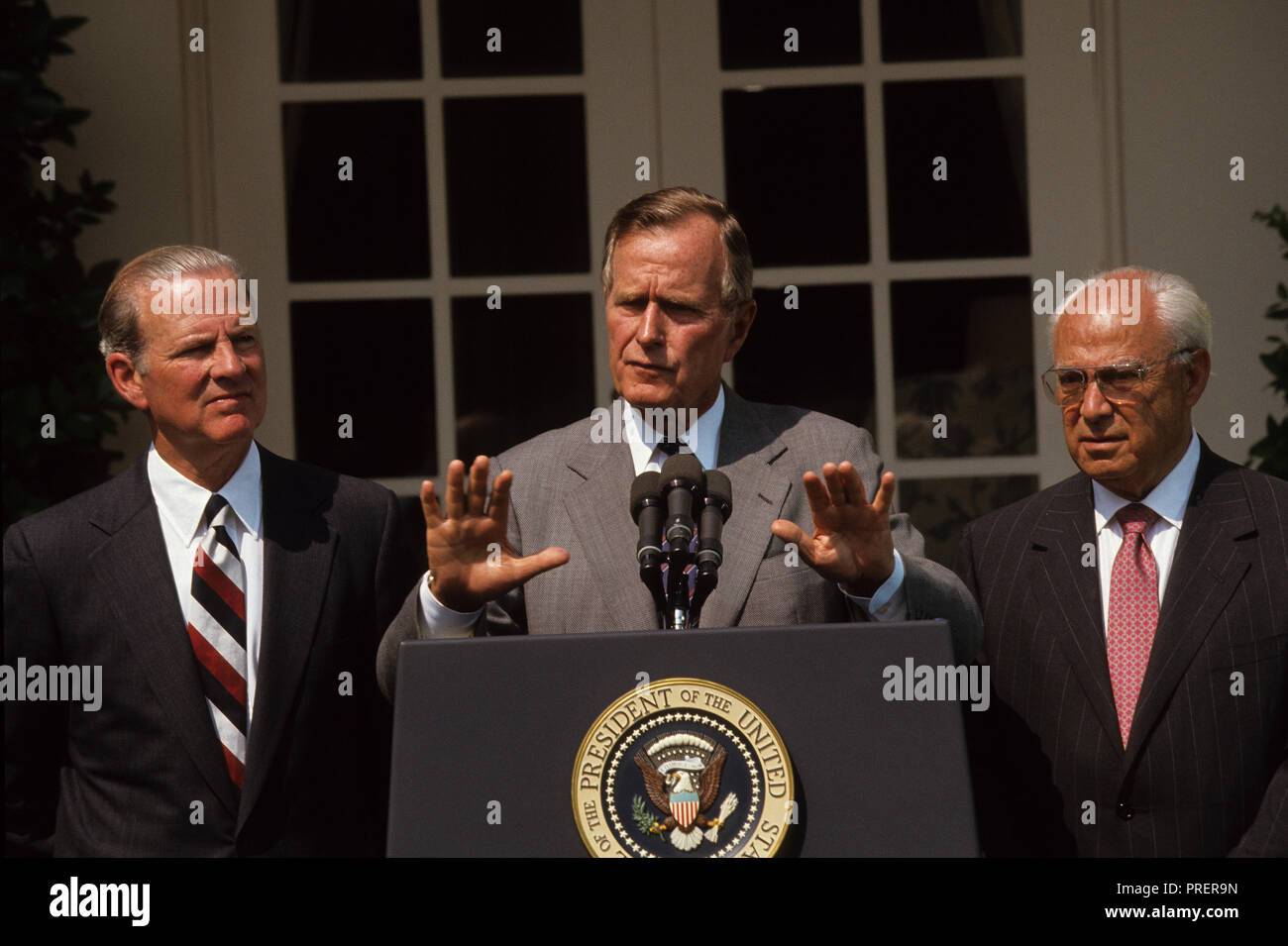 President HW Bush  (Bush 41) making a statement in the Rose Garden of the White House with James Baker and Robert Strauss    Photograph by Dennis Brack bb24 Stock Photo