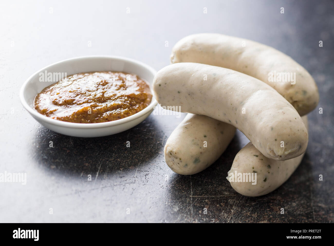 The bavarian weisswurst and mustard on kitchen table. Stock Photo