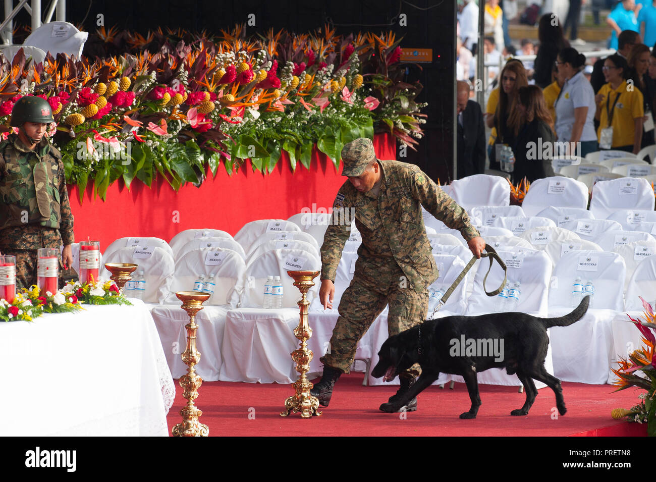 A soldier with a bomb sniffing dog inspects the area around the alter at San Salvador's Plaza Salvador del Mundo - site of the martyred Archbishop Romero's beatification mass. No violence was reported at Saturdsy's event. El Salvador celebrated the ceremony and mass announcing the beatification of Archbishop Oscar Romero. The Archbishop was slain at the alter of his Church of the Divine Providence by a right wing gunman in 1980. Oscar Arnulfo Romero y Galdamez became the fourth Archbishop of San Salvador, succeeding Luis Chavez, and spoke out against poverty, social injustice, assassinations a Stock Photo
