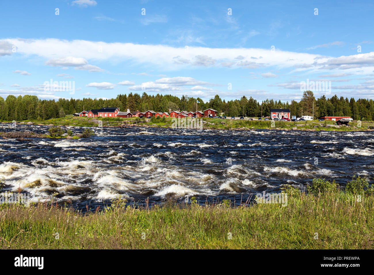KUKKOLAFORSEN, SWEDEN ON JUNE 27, 2018. View of the river and the Finnish village Kukkola. Buildings and vehicle. Editorial use. Stock Photo