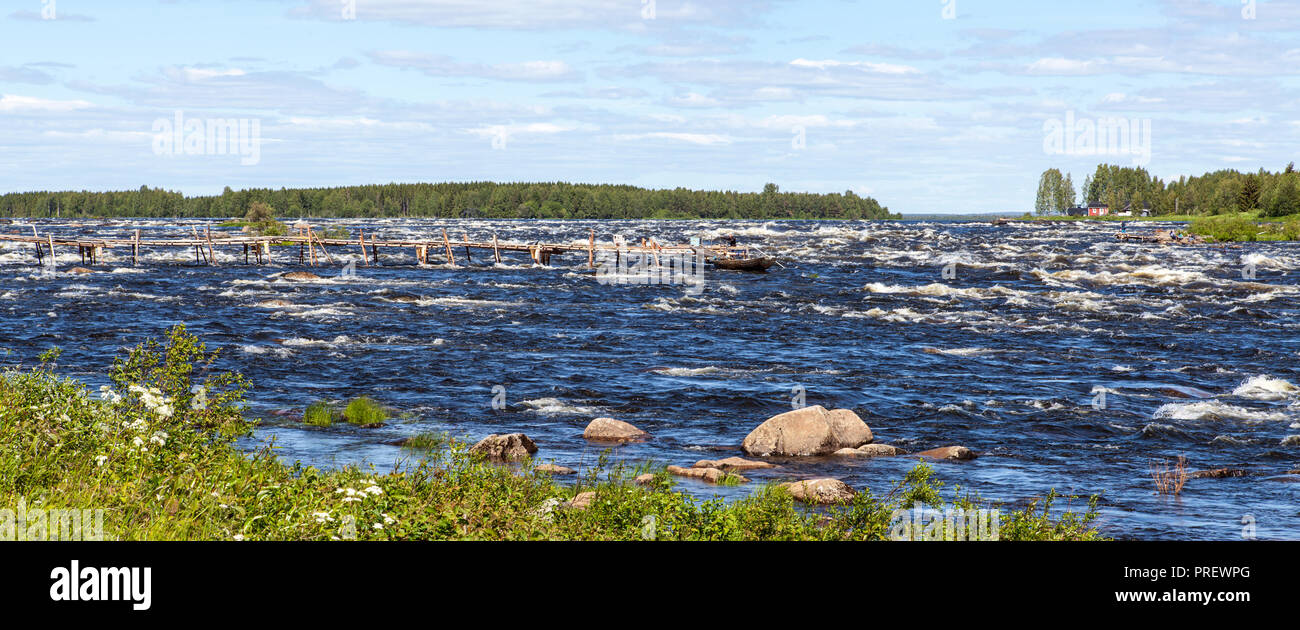 KUKKOLAFORSEN, SWEDEN ON JUNE 27, 2018. View of the river and the village Kukkola. Buildings and unidentified people. Editorial Stock Photo