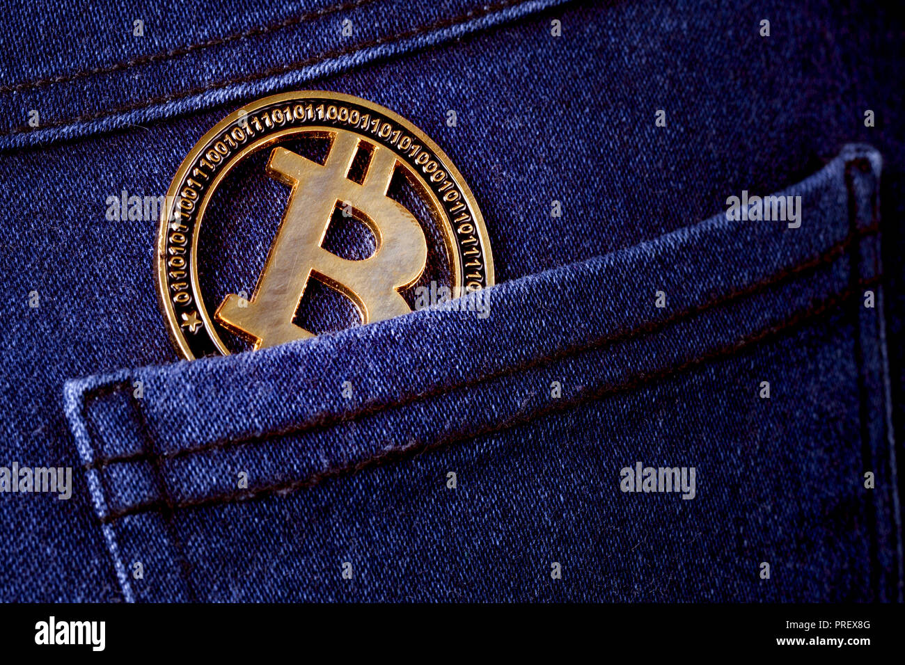 gold bitcoin in the back pocket of jeans, background image Stock Photo -  Alamy