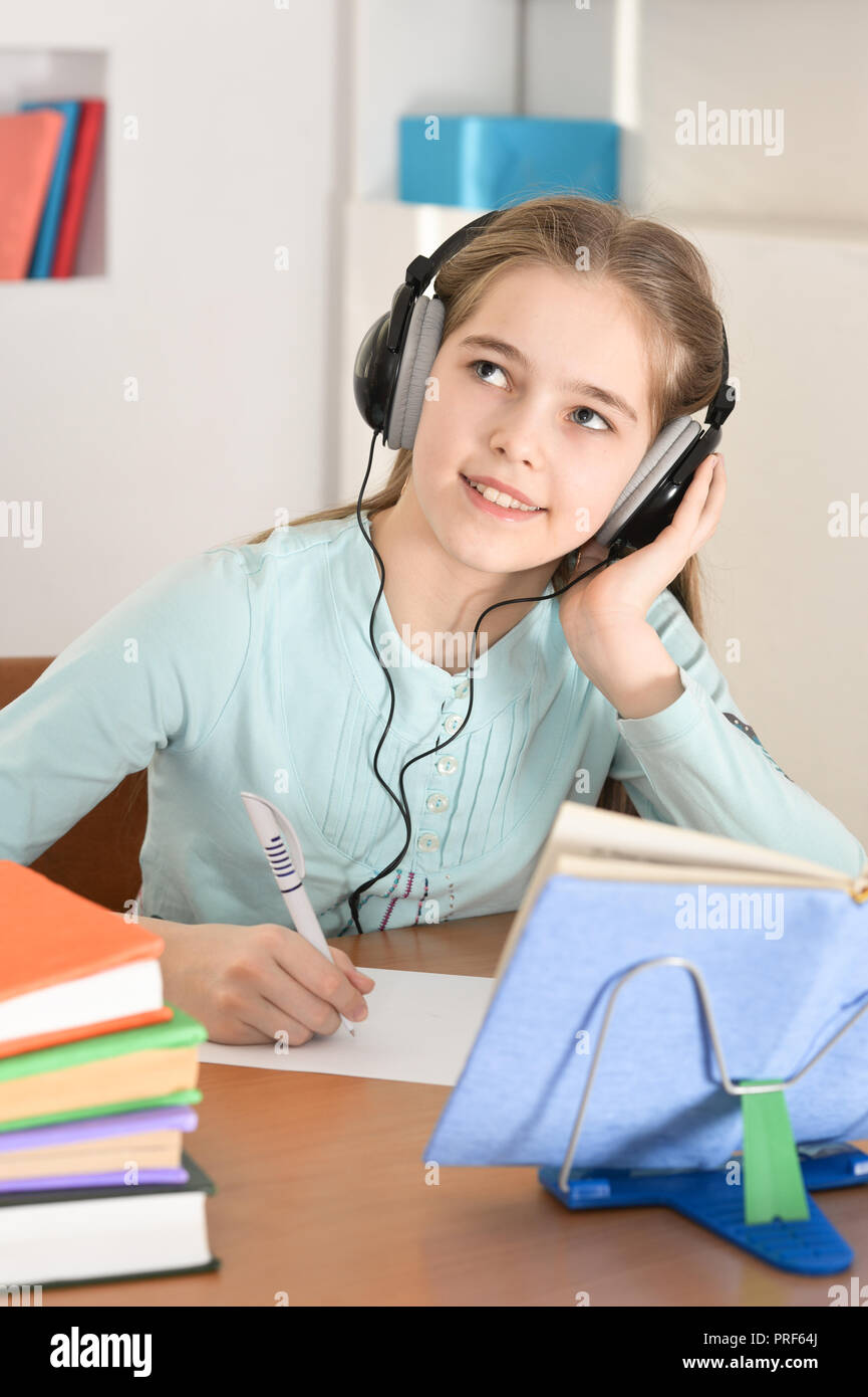 cute-schoolgirl-in-headphones-studying-at-home-stock-photo-alamy
