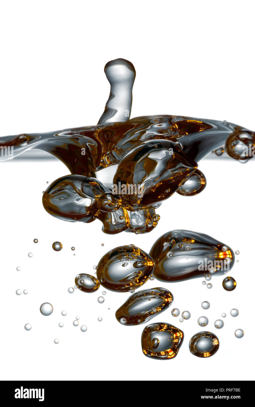 Water splash. Liquid poured into vessel. View through glass wall, isolated. Stock Photo