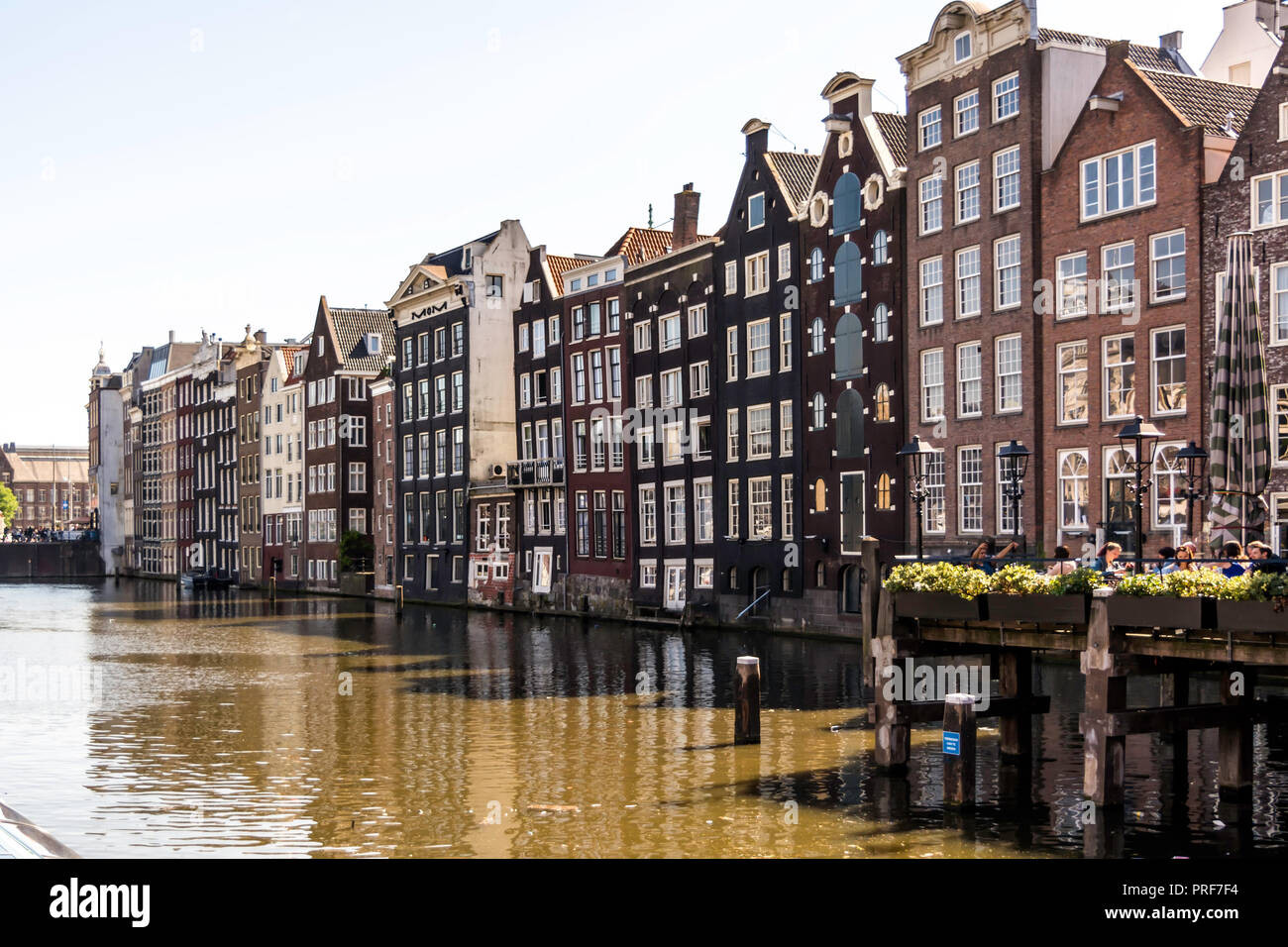 Picturesque traditional canal houses with gabled facades along the street. Stock Photo