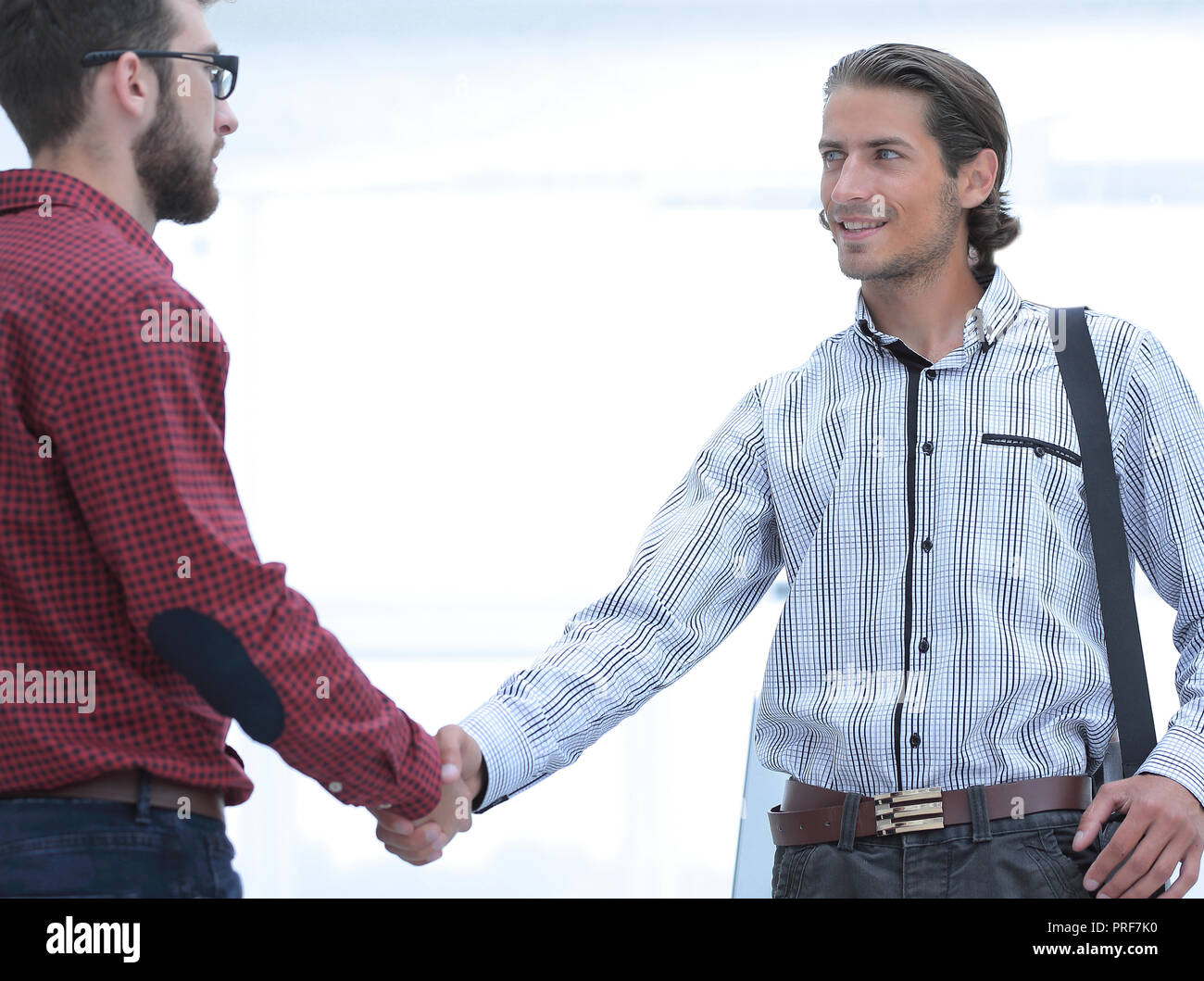 Business colleagues shaking hands at office Stock Photo