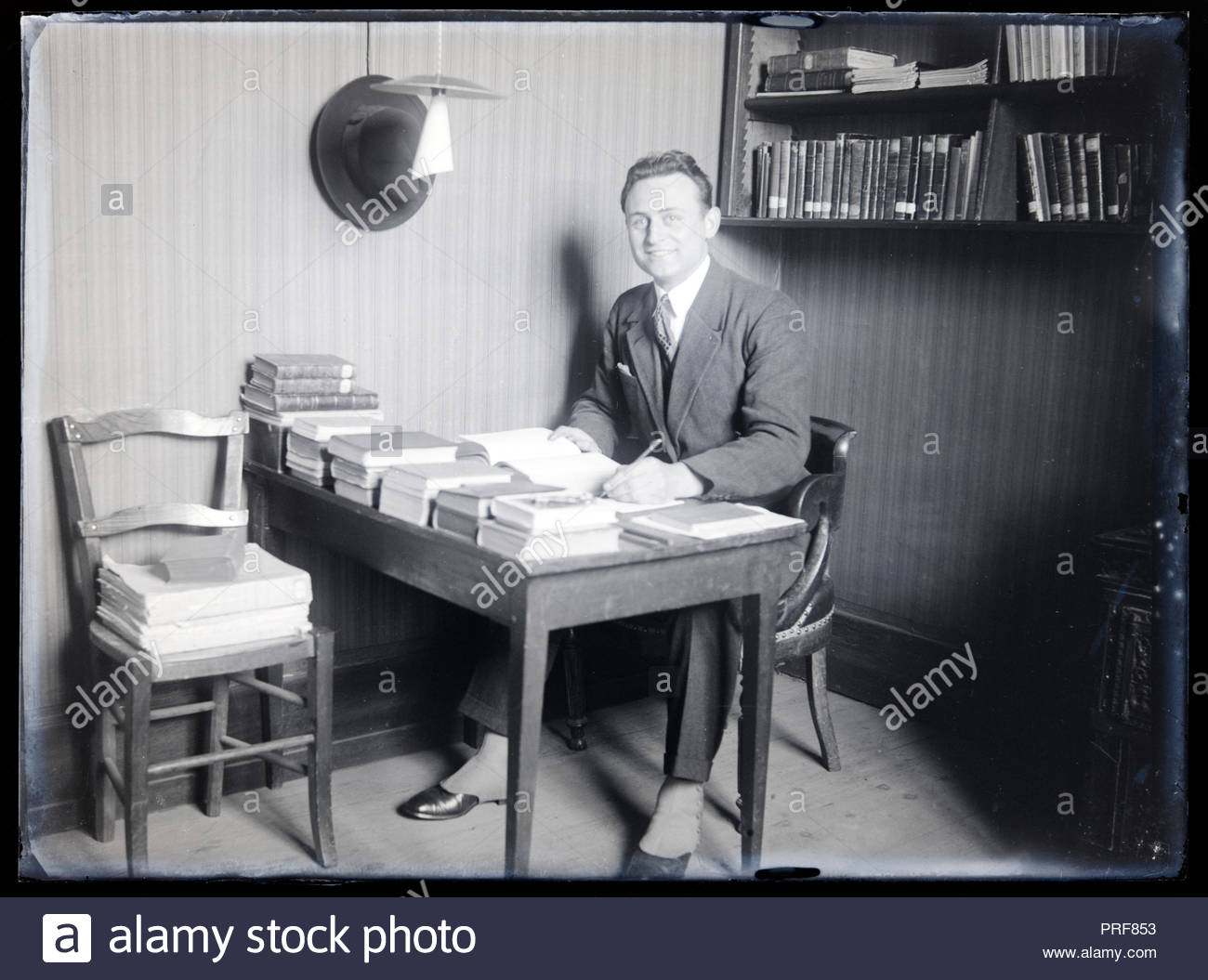 Writer Or Librarian With Books Sitting On A Table France Circa