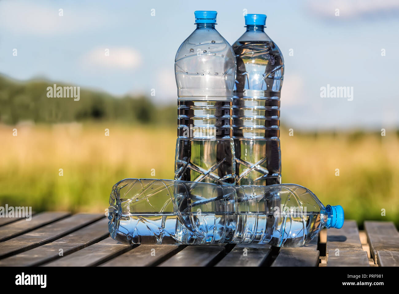 https://c8.alamy.com/comp/PRF981/drinking-water-in-plastic-bottles-outdoors-PRF981.jpg