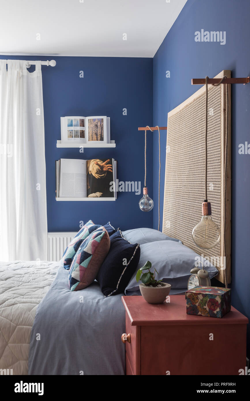 Lightbulbs Hang On Rope With Large Headboard In Blue
