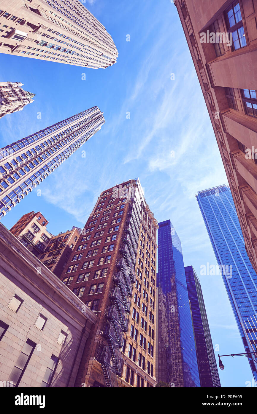 Vintage stylized photo of Manhattan modern and old skyscrapers, looking