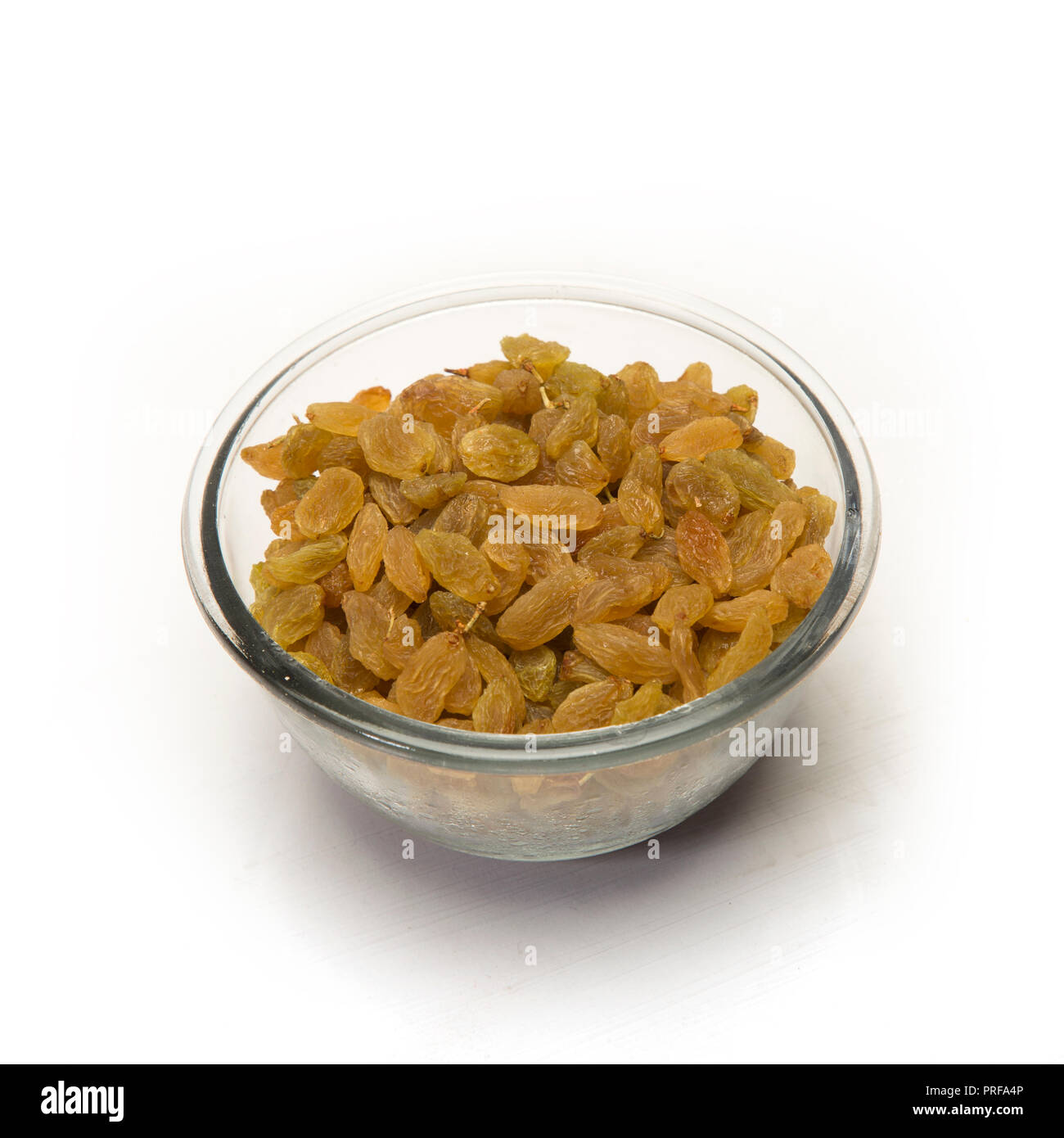Dried raisin in glass bowl isolated on white background Stock Photo Alamy