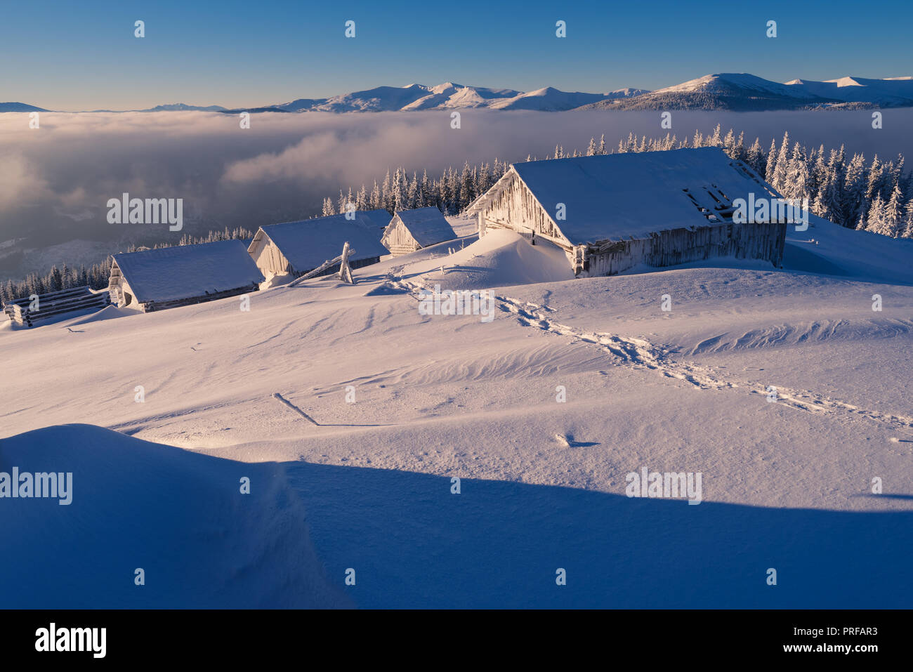 Winter landscape. Wooden houses in the snow. Mountain village of ...