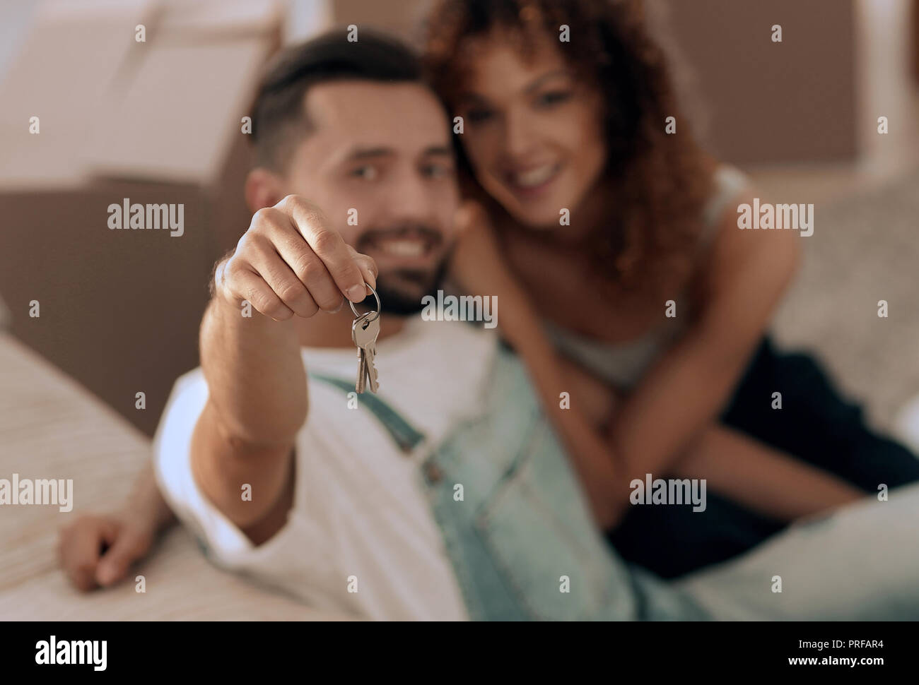 young couple holding the key to a new apartment Stock Photo - Alamy