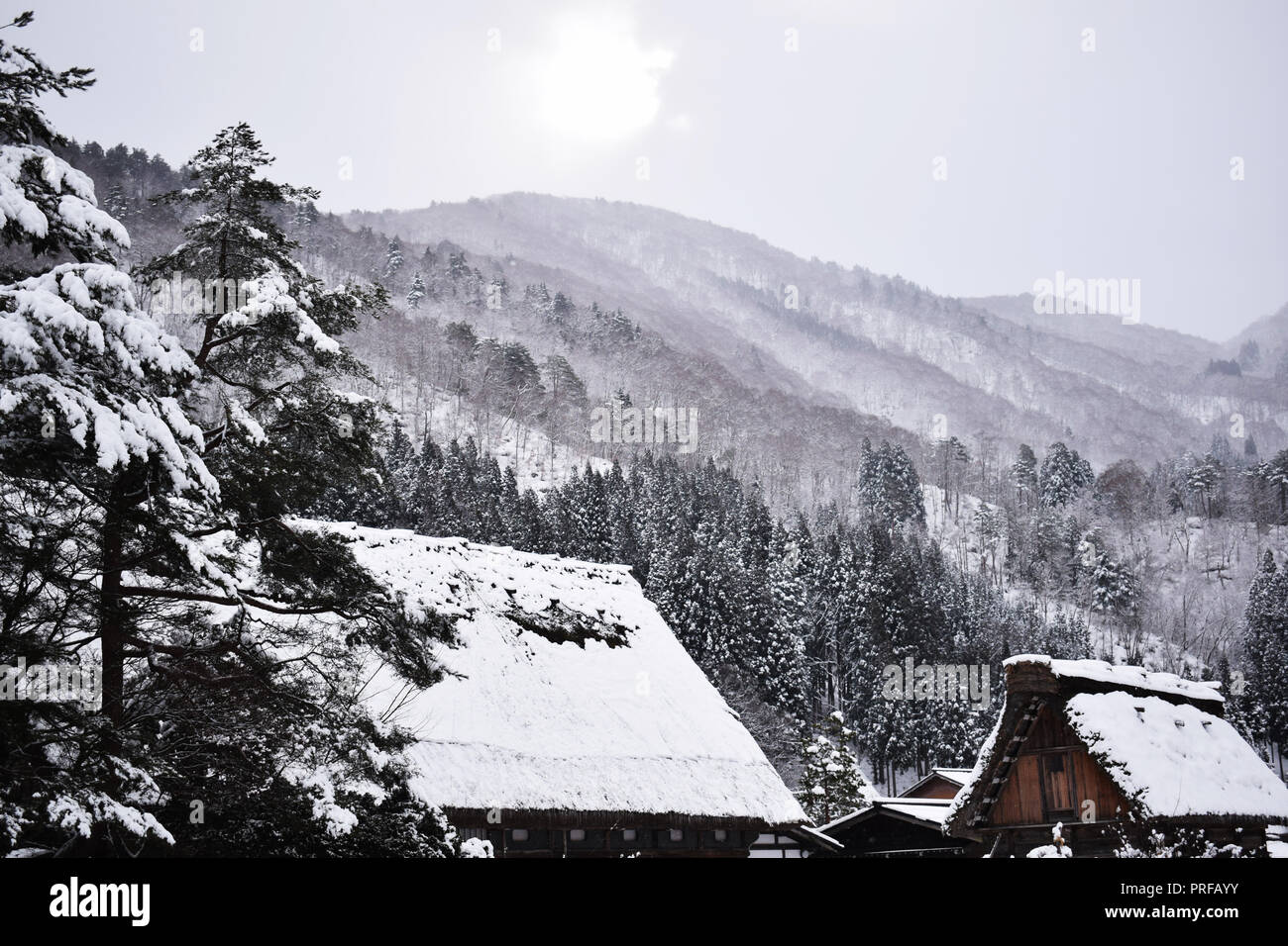 Winter sun over mountains in Shirakawa-go Stock Photo