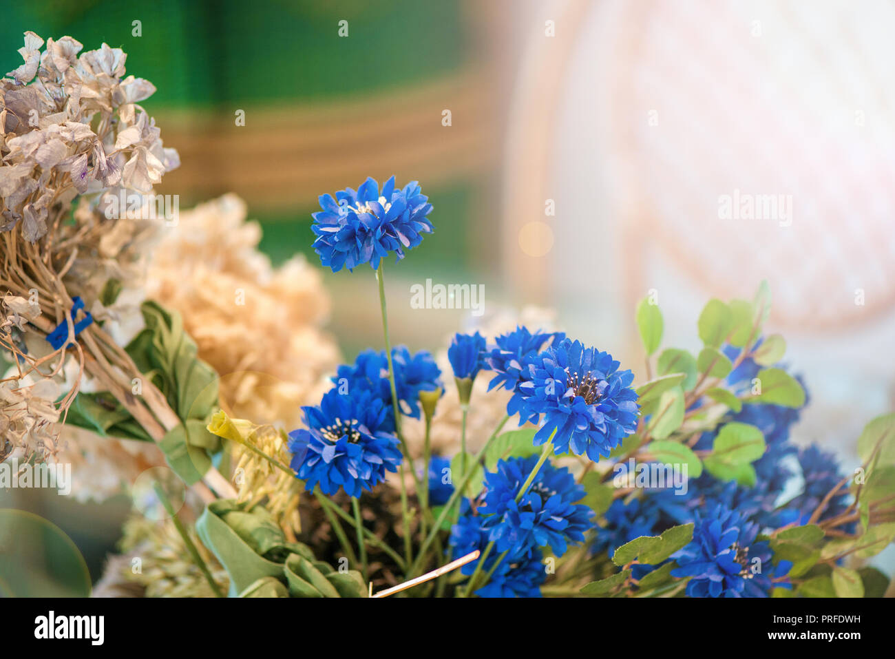 Dried blue flowers and wheat, wicker chairs in dining room with big glass  table and decorations. Cozy, vintage, rustic atmosphere at home. Concept of  Stock Photo - Alamy