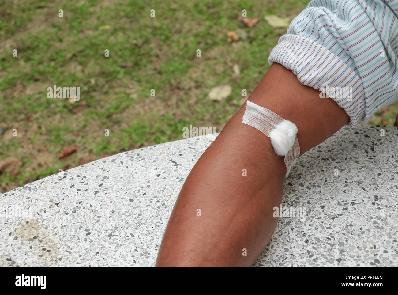 Bandage and gauze on an arm after a blood test :Select focus with shallow  depth of field Stock Photo - Alamy