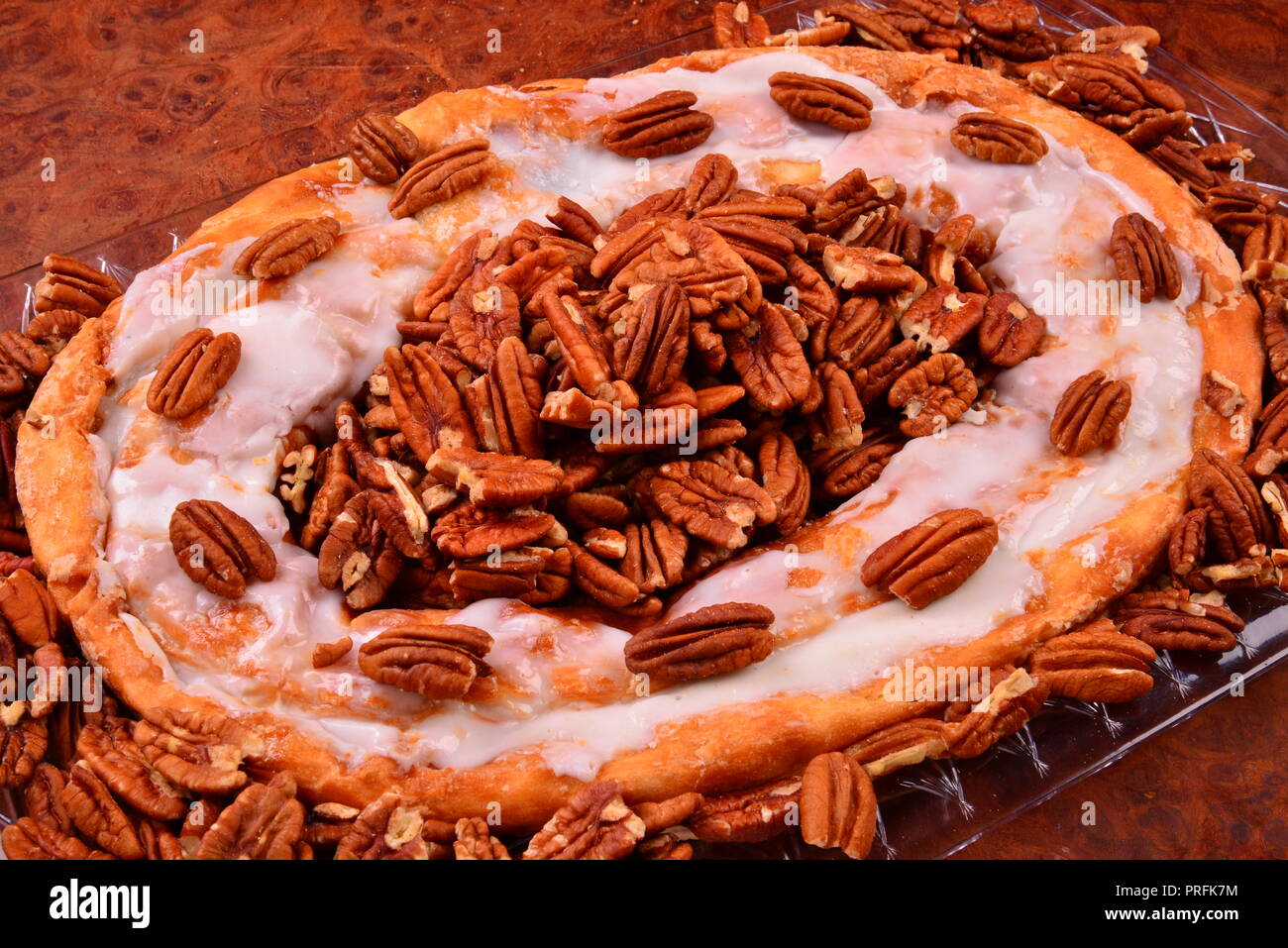 The sweet pastry treat pecan Kringle from Racine Wisconsin is a local favorite surrounded by pecans. Stock Photo