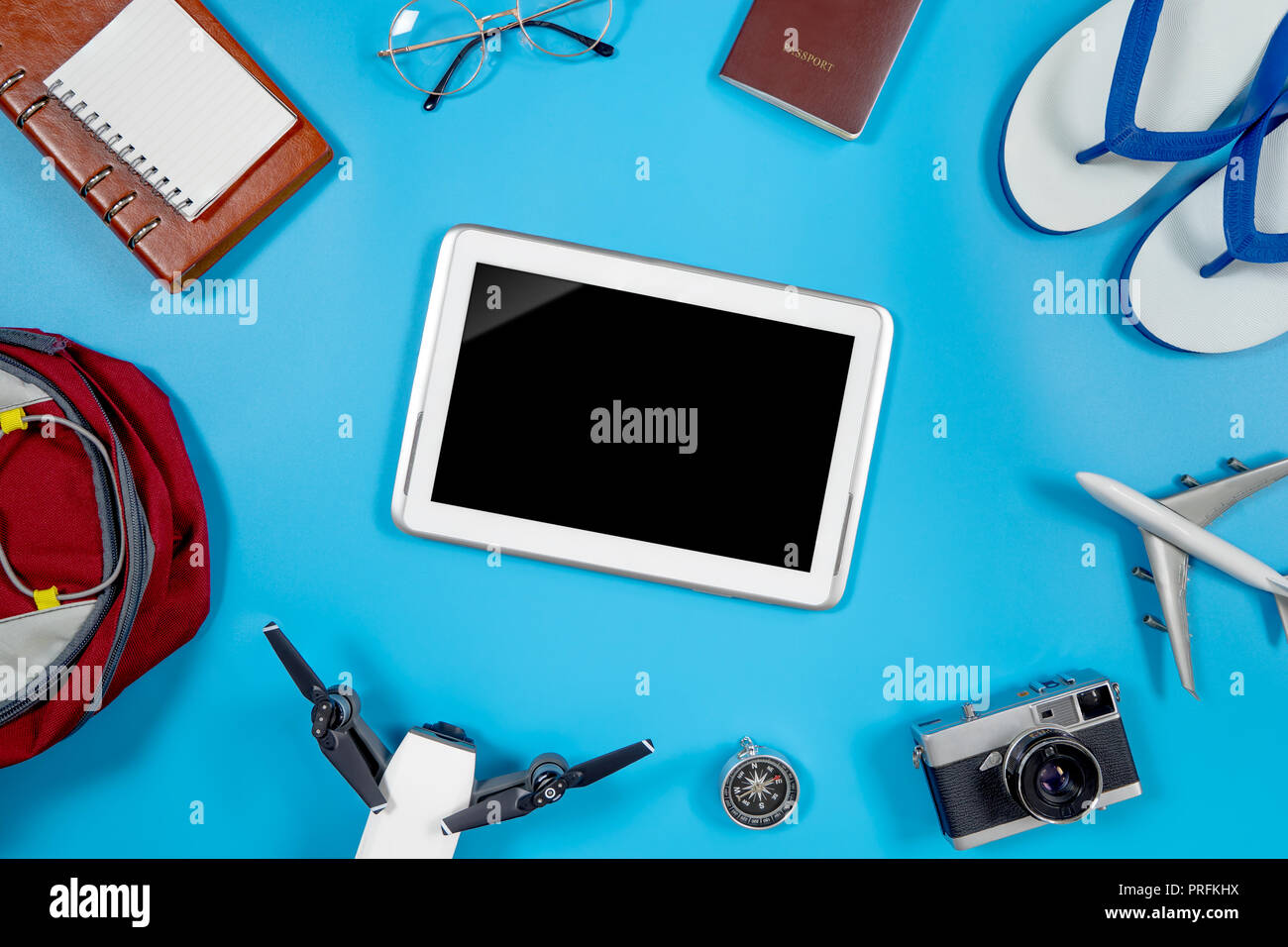 Blank Tablet screen surrounding by summer travel objects Stock Photo