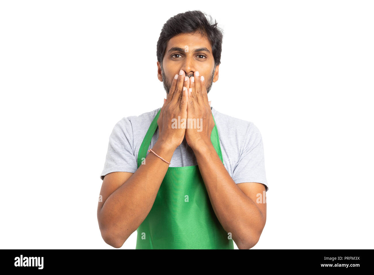 Hypermarket or supermarket indian man employee using hands to cover mouth as speechless concept isolated on white background Stock Photo