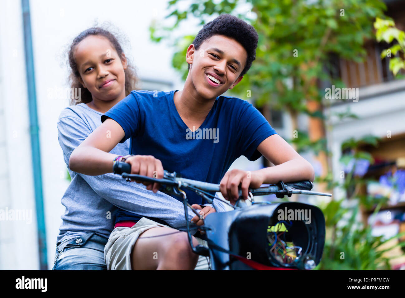 Happy brother and sister riding motorcycle Stock Photo - Alamy