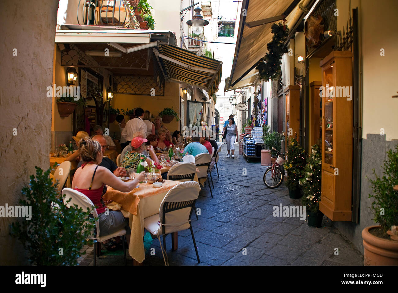 Restaurants and shops at a narrow alley, old town of Sorrento, Peninsula of Sorrento, Gulf of Naples, Campania, Italy Stock Photo